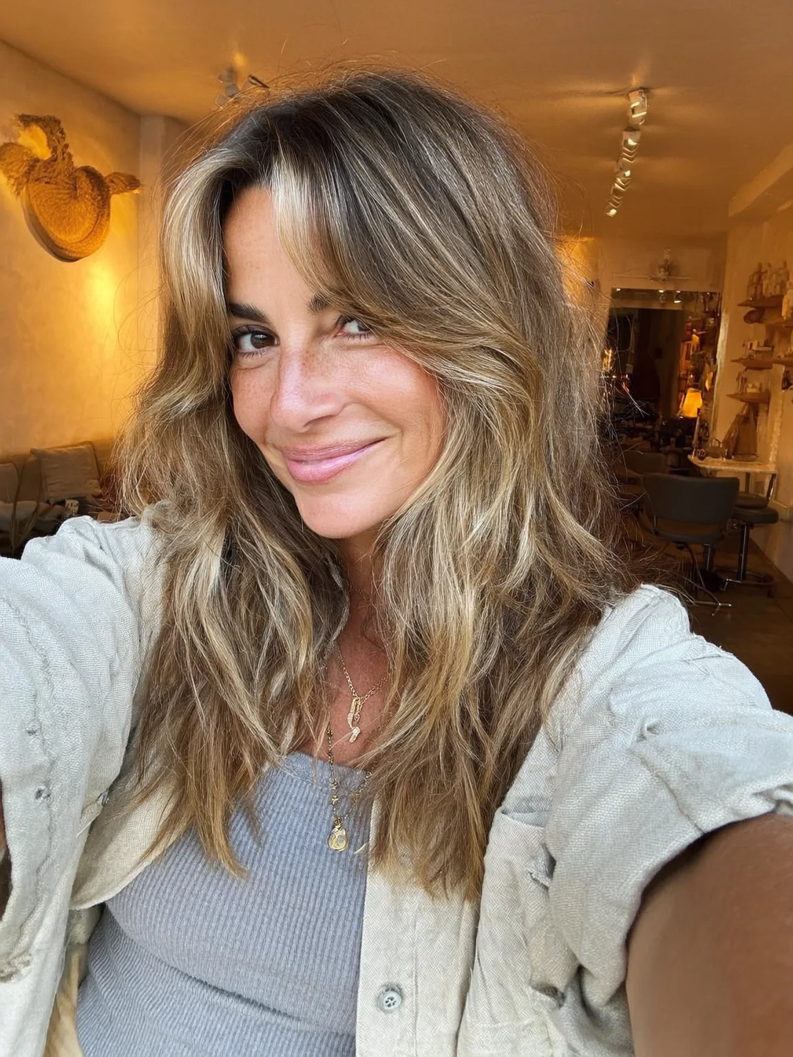 Long Layered Sandy Blonde Shag with Sun-Kissed Highlights